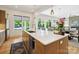Well-appointed kitchen with an island, stainless steel appliances, and views of the backyard pool creating an inviting space at 1009 Belmont Ave, Charlotte, NC 28205