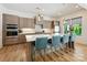 Modern kitchen with a large center island, quartz countertops, stainless steel appliances, and stylish pendant lighting at 1009 Belmont Ave, Charlotte, NC 28205