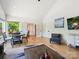 Spacious living area featuring wood floors, neutral walls, a ceiling fan, and oversized windows at 1009 Belmont Ave, Charlotte, NC 28205