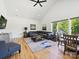 Bright living room featuring vaulted ceilings, hardwood floors, and a large window with wooded views at 1009 Belmont Ave, Charlotte, NC 28205