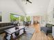 Open-concept living room with a vaulted ceiling, hardwood floors, and plenty of natural light at 1009 Belmont Ave, Charlotte, NC 28205