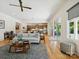 Bright and airy living room with a view into the kitchen and dining area, featuring hardwood floors and contemporary decor at 1009 Belmont Ave, Charlotte, NC 28205
