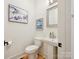 Clean powder room featuring pedestal sink, white toilet and decor at 1009 Belmont Ave, Charlotte, NC 28205
