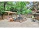 Beautiful outdoor fountain situated on a brick patio surrounded by greenery and seating at 10209 Thomas Payne Cir, Charlotte, NC 28277