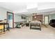 Spacious carpeted basement with a brick fireplace and neutral colored furniture at 10209 Thomas Payne Cir, Charlotte, NC 28277