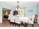 Elegant dining room featuring a chandelier, patterned chairs, and plenty of natural light at 10209 Thomas Payne Cir, Charlotte, NC 28277