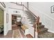 Inviting foyer with staircase, patterned carpet, wainscotting, and glimpses of a cozy living space at 10209 Thomas Payne Cir, Charlotte, NC 28277
