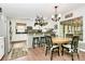 Bright eat-in kitchen with stainless appliances, pot rack, breakfast bar, and table with seating for four at 10209 Thomas Payne Cir, Charlotte, NC 28277