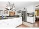 Well-lit kitchen features granite countertops, stainless steel appliances, and a pot rack over the stove at 10209 Thomas Payne Cir, Charlotte, NC 28277