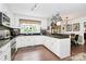 Bright kitchen equipped with stainless steel appliances, white cabinetry, and black countertops at 10209 Thomas Payne Cir, Charlotte, NC 28277