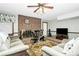 Living room features a fireplace, ceiling fan and plush seating at 10209 Thomas Payne Cir, Charlotte, NC 28277