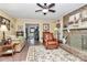 Cozy living room with a brick fireplace, comfortable seating, and access to the kitchen at 10209 Thomas Payne Cir, Charlotte, NC 28277