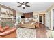 Comfortable living room with a brick fireplace, ceiling fan, and hardwood floors at 10209 Thomas Payne Cir, Charlotte, NC 28277