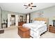 Spacious main bedroom with a dresser, lamps, and view into the en suite bathroom at 10209 Thomas Payne Cir, Charlotte, NC 28277