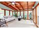 Bright sunroom features vaulted wood ceiling, comfortable seating, and green plants at 10209 Thomas Payne Cir, Charlotte, NC 28277