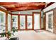 Enclosed sunroom with vaulted wood ceiling with lots of windows providing natural light at 10209 Thomas Payne Cir, Charlotte, NC 28277