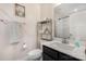 Bathroom featuring a modern sink, white tile shower, and decorative shelving at 10436 Dalton Woods Nw Ct, Huntersville, NC 28078