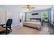 Bright bedroom features a ceiling fan and outdoor views from the two large windows at 10436 Dalton Woods Nw Ct, Huntersville, NC 28078
