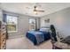 Bedroom featuring plush bedding, a ceiling fan, and large windows at 10436 Dalton Woods Nw Ct, Huntersville, NC 28078