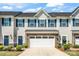 Charming townhome with a two-car garage, blue shutters, and a beautifully landscaped front yard at 10436 Dalton Woods Nw Ct, Huntersville, NC 28078