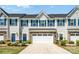 Charming townhome with a two-car garage, blue shutters, and a beautifully landscaped front yard at 10436 Dalton Woods Nw Ct, Huntersville, NC 28078