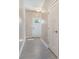 Inviting entryway featuring light gray wood-look flooring and a view of the front door at 10436 Dalton Woods Nw Ct, Huntersville, NC 28078