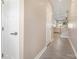 Bright hallway with wood-look floors leading to an open living area with stairs at 10436 Dalton Woods Nw Ct, Huntersville, NC 28078
