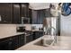 Modern kitchen featuring stainless steel appliances, dark cabinets, and a quartz countertop at 10436 Dalton Woods Nw Ct, Huntersville, NC 28078
