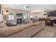 Cozy living room with a fireplace, large sectional sofa, and an open layout at 10436 Dalton Woods Nw Ct, Huntersville, NC 28078