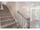 View of the carpeted stairway featuring a wooden handrail at 10436 Dalton Woods Nw Ct, Huntersville, NC 28078