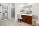 Bathroom featuring vanity, tiled floor, glass shower, and an open doorway at 109 Braxton Gate Ct, Mount Holly, NC 28120