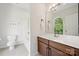 Bathroom featuring vanity, tub-shower combo, large mirror and decorative window at 109 Braxton Gate Ct, Mount Holly, NC 28120
