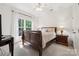 Bright bedroom with a sleigh bed, side tables and neutral carpeting at 109 Braxton Gate Ct, Mount Holly, NC 28120