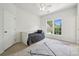 Bright bedroom with a twin bed, large windows, and neutral carpeting at 109 Braxton Gate Ct, Mount Holly, NC 28120