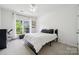 Bedroom with a large window, ceiling fan, and neutral carpeting at 109 Braxton Gate Ct, Mount Holly, NC 28120