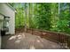 Spacious wooden deck surrounded by lush green trees at 109 Braxton Gate Ct, Mount Holly, NC 28120