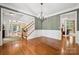 Elegant dining room with hardwood floors, chandelier, and access to multiple rooms, including the staircase and living area at 109 Braxton Gate Ct, Mount Holly, NC 28120
