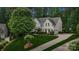 Charming two-story home with a well-manicured lawn, mature trees, and a long driveway leading to an attached garage at 109 Braxton Gate Ct, Mount Holly, NC 28120