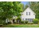 Charming two-story home with a manicured lawn, complemented by mature trees and shrubs, offering curb appeal at 109 Braxton Gate Ct, Mount Holly, NC 28120
