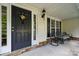 Charming front porch with rocking chairs and a decorative wreath on the door at 109 Braxton Gate Ct, Mount Holly, NC 28120