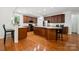Spacious kitchen features hardwood floors, expansive island, stainless appliances, and ample cabinet space at 109 Braxton Gate Ct, Mount Holly, NC 28120