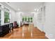 Inviting living room features hardwood floors, built-in bookshelves, and lots of natural light at 109 Braxton Gate Ct, Mount Holly, NC 28120
