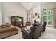 Spacious living room with vaulted ceilings, a fireplace, large windows, and comfortable seating at 109 Braxton Gate Ct, Mount Holly, NC 28120