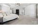 Bright main bedroom features a tray ceiling, neutral carpet, and an armoire at 109 Braxton Gate Ct, Mount Holly, NC 28120