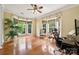 Bright office space featuring multiple windows, wood floors, and a ceiling fan at 109 Braxton Gate Ct, Mount Holly, NC 28120