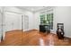 Bright office space with hardwood floors, large windows, and a calming view of the outdoors at 109 Braxton Gate Ct, Mount Holly, NC 28120