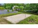 Outdoor volleyball court surrounded by lush greenery, a parking lot, and community amenities in the background at 109 Braxton Gate Ct, Mount Holly, NC 28120