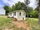 Exterior back view, showcasing clean design, yard and lush greenery at 1105 S Church S St, Monroe, NC 28112