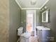 A charming full bathroom offers a white vanity and tiles, plus a mirror and great lighting at 1105 S Church S St, Monroe, NC 28112
