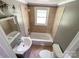 A charming full bathroom offers a modern vanity and shower-tub combination, plus mirror and lighting at 1105 S Church S St, Monroe, NC 28112